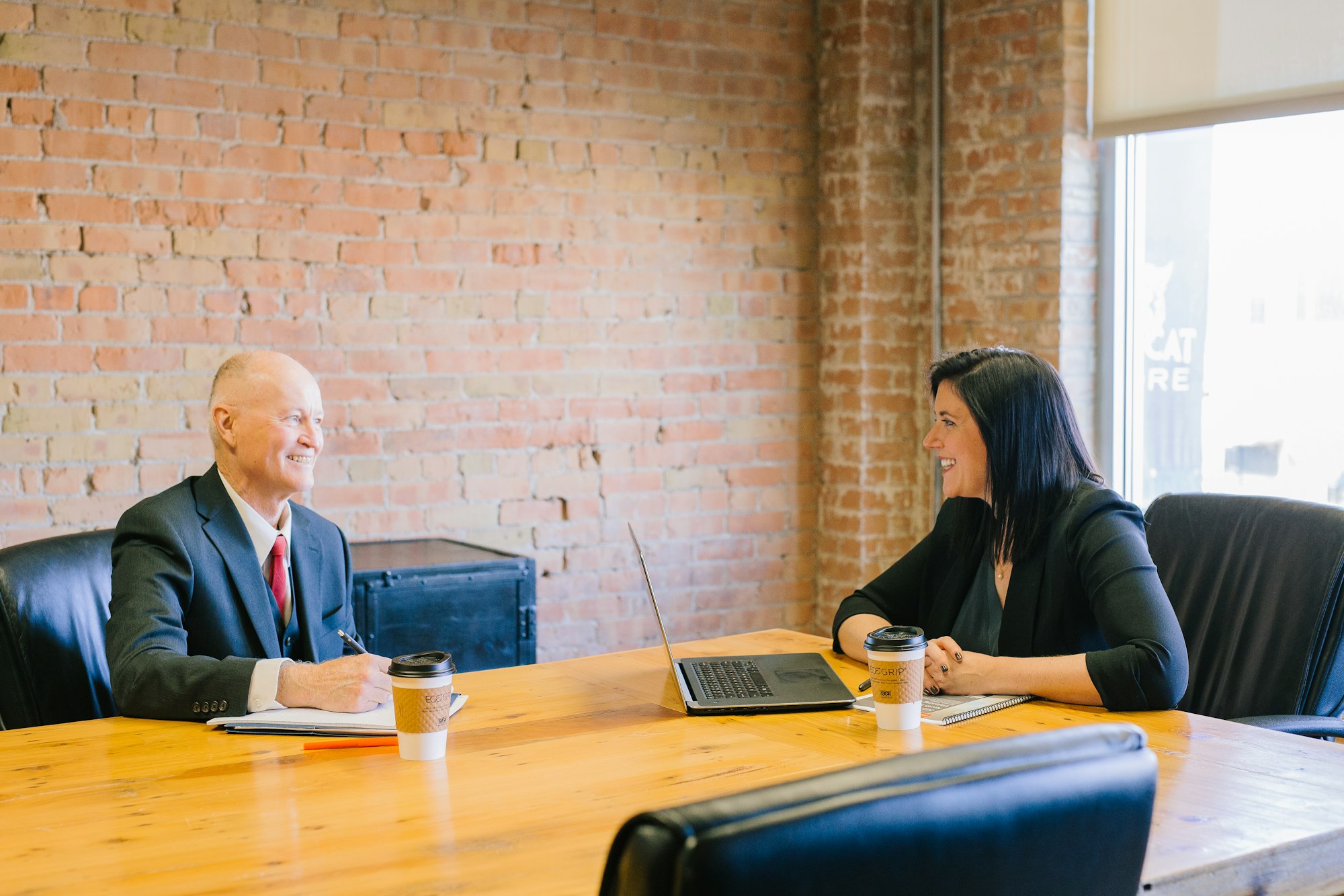 An owner and an accountant talking through the business at a table